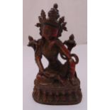 A gilt copper alloy figurine of Tara Tibet on raised base decorated with stylised lotus leaves, 33.