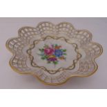A Dresden circular pierced porcelain fruit bowl decorated with flowers, leaves and gilded borders,