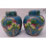 A pair of oriental cloisonné ginger jars and covers decorated with flowers, leaves and fruit, 24.5cm