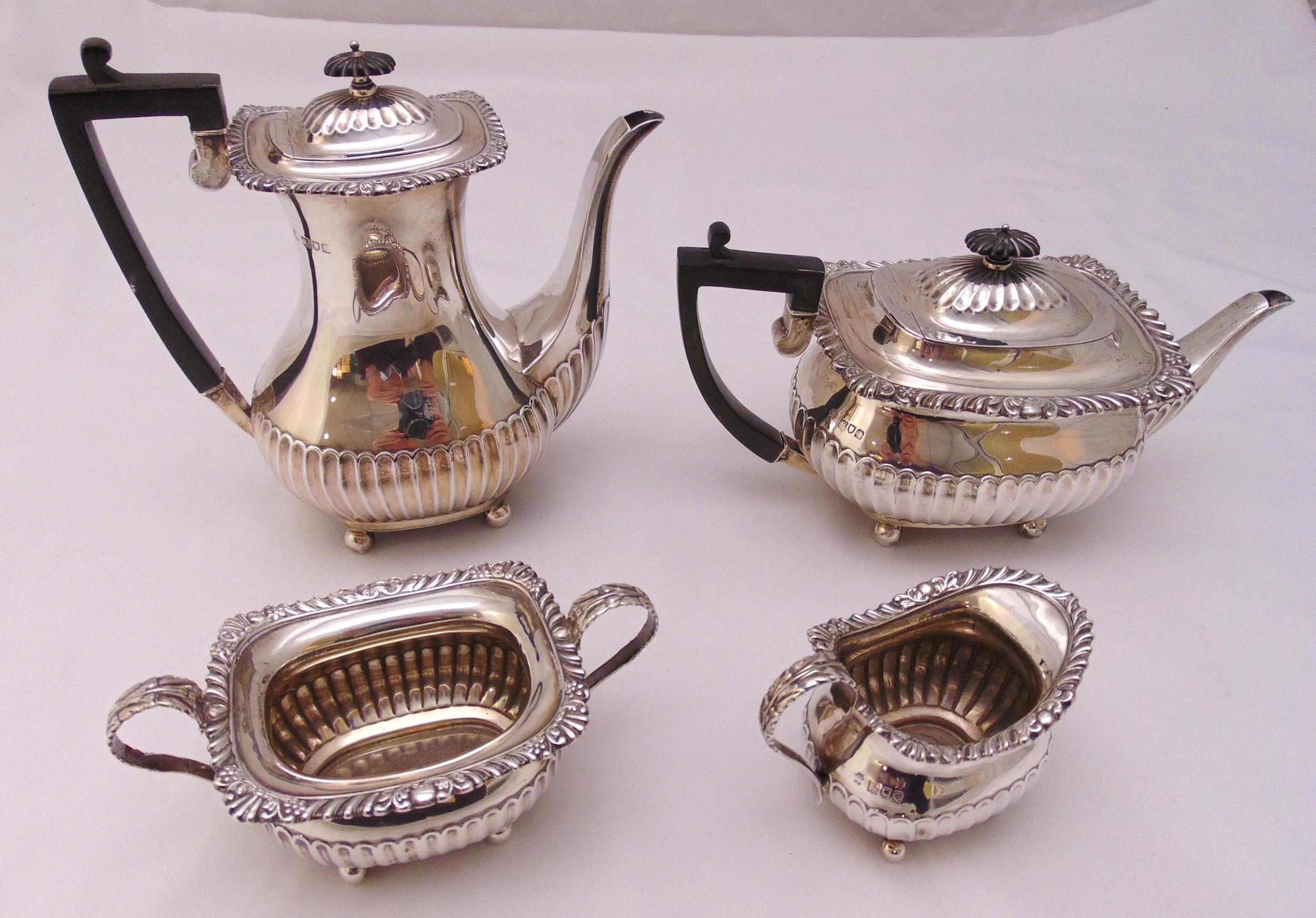 A hallmarked silver four piece tea and coffee set, rounded rectangular, part fluted with shell and