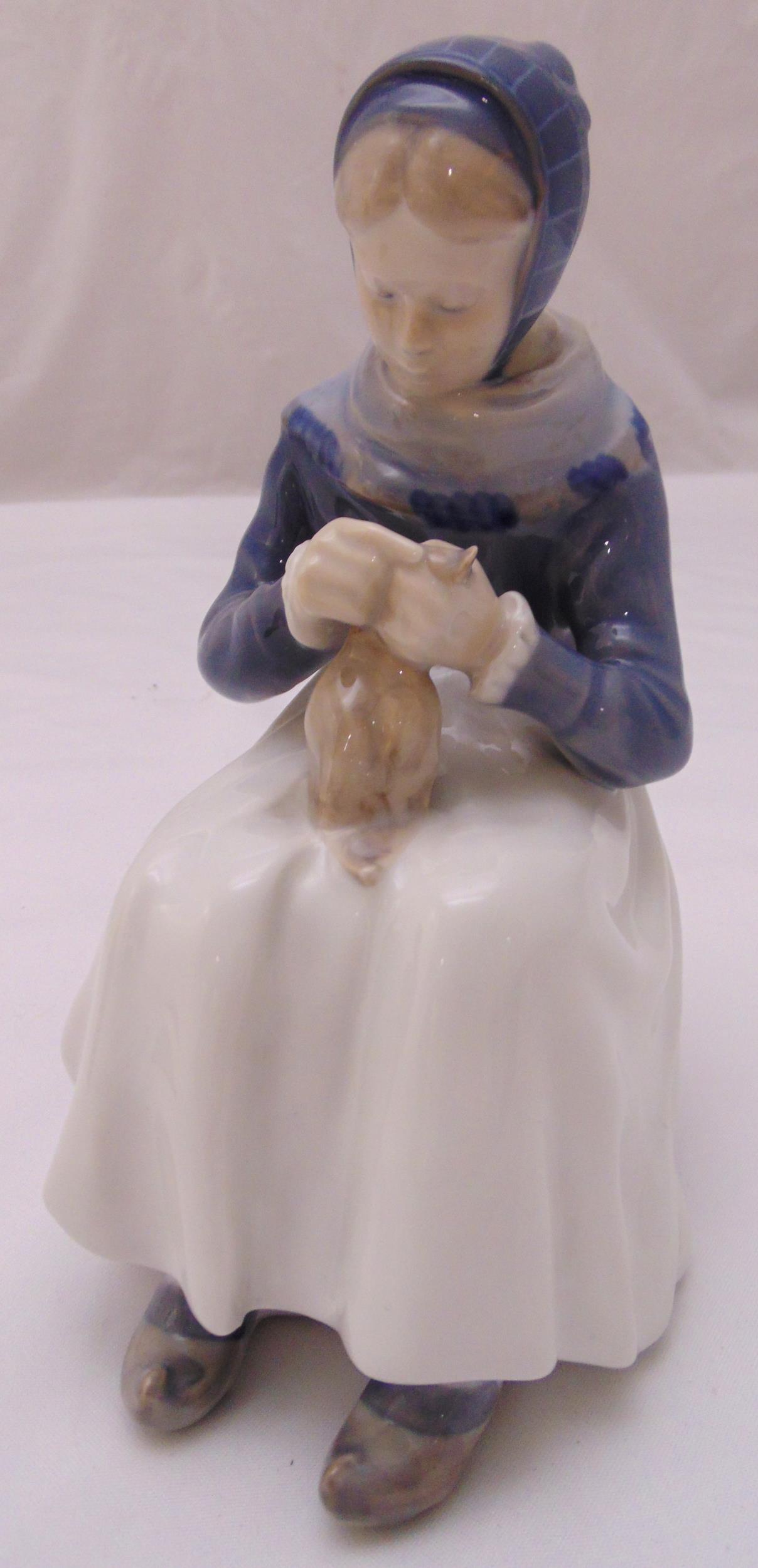 A Royal Copenhagen figurine 1317 of an Amager woman knitting, 23cm (h)