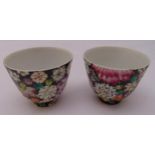 A pair of Qing dynasty polychrome floral tea cups, marks to the bases, 6cm (h)