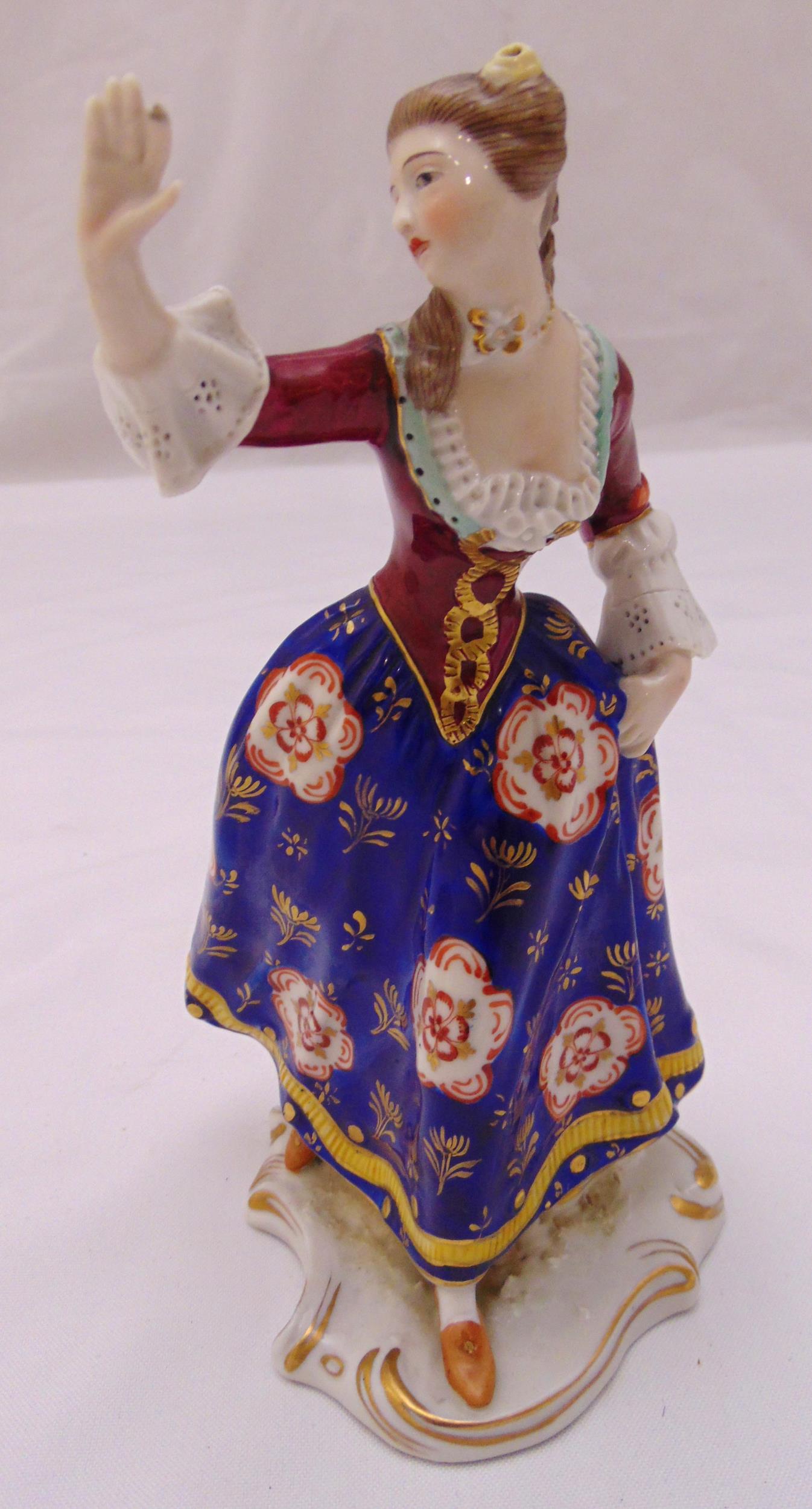 A Crown Derby figurine of a lady in 19th century attire on shaped oval base, marks to verso, 18cm (