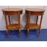 A pair of continental mahogany and Kingswood oval side tables with single drawer on four scroll