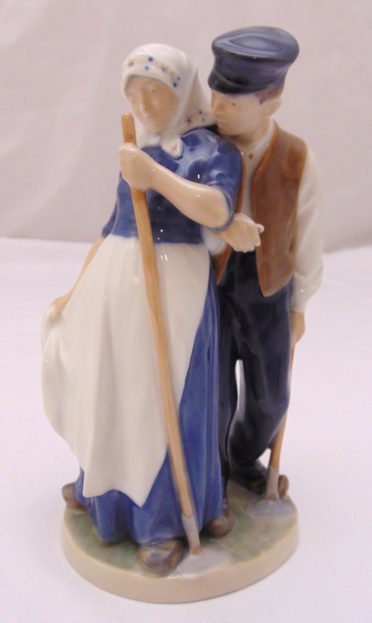 Royal Copenhagen figurine of a harvest farm couple on shaped oval base 1300, marks to the base, 19.