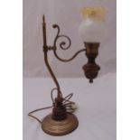 A Victorian style brass and wooden table lamp, the scrolling arm supporting a lamp with fluted