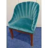 An Art Deco upholstered tub chair with fluted scalloped back on four outswept legs