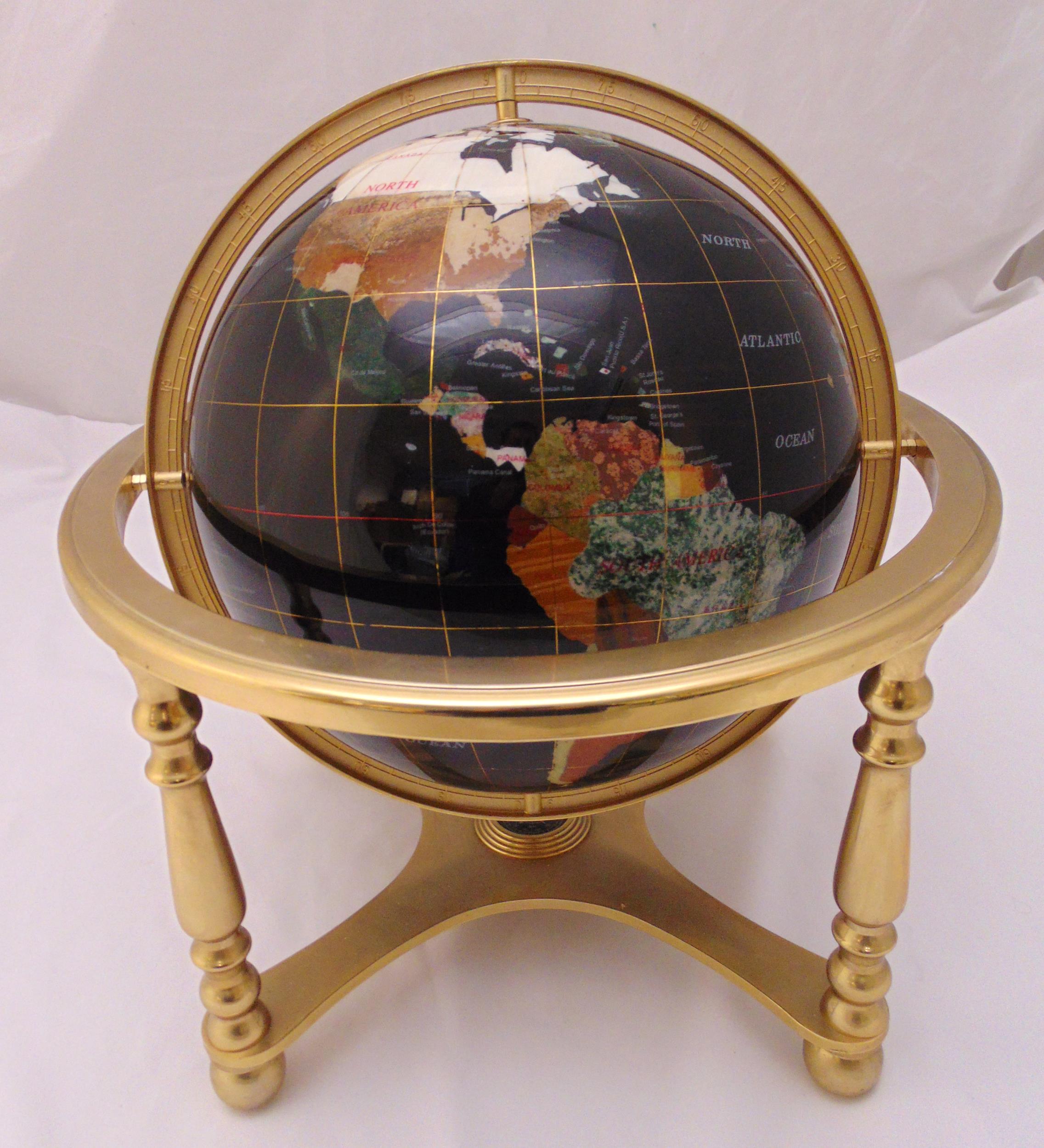 A terrestrial globe, polychromatic in a turned brass stand on four cast baluster supports, 47cm (h)