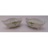A pair of Sitzendorf porcelain oval pierced dishes on four scroll feet decorated with flowers and