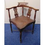 An Edwardian mahogany inlaid corner chair on four turned legs with leather upholstered seat and