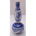 An oriental blue and white double gourd vase decorated with floral sprays, 31cm (h)