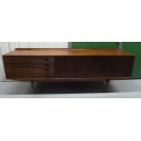 A mid 20th century Rosewood rectangular sideboard with cupboards and four drawers with turned wooden