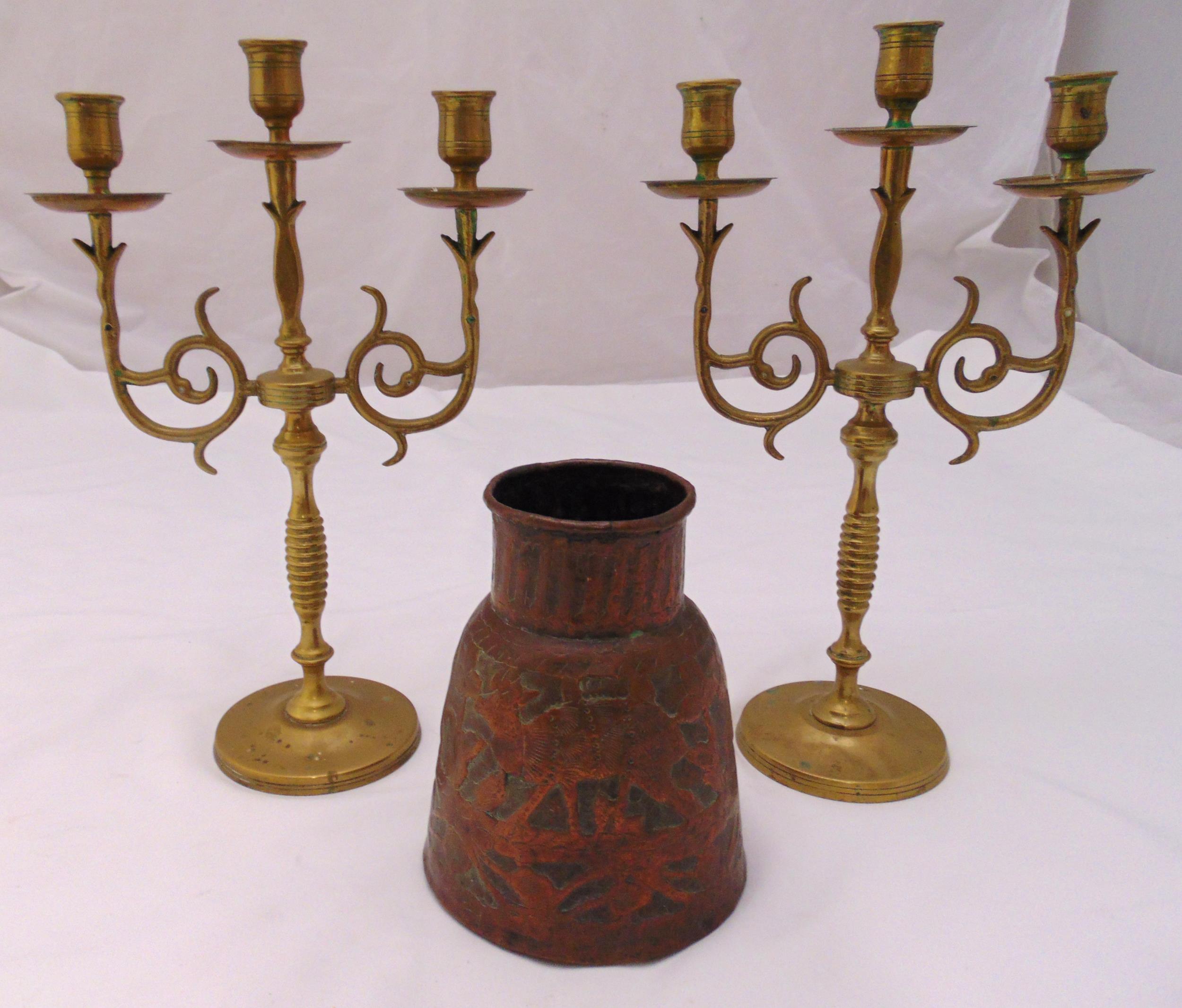 A pair of brass three light candelabra, 34.5cm and a copper conical vase chased with deer and trees,