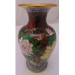 An oriental cloisonné baluster vase decorated with flowers and butterflies on raised circular