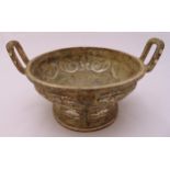 A silvered archaic bronze censer of circular form with pierced side handles on raised circular base,