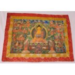 A rectangular Tibetan silk Tanka with polychromatic deities within stylised scroll and leaf borders,