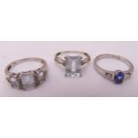 Two 9ct white gold aquamarine and diamond rings and a 9ct white gold sapphire and diamond ring,