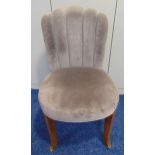 An Art Deco upholstered chair with fluted back on four outswept legs
