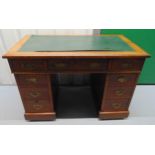 An early 20th century rectangular mahogany pedestal desk with tooled leather top and brass swing