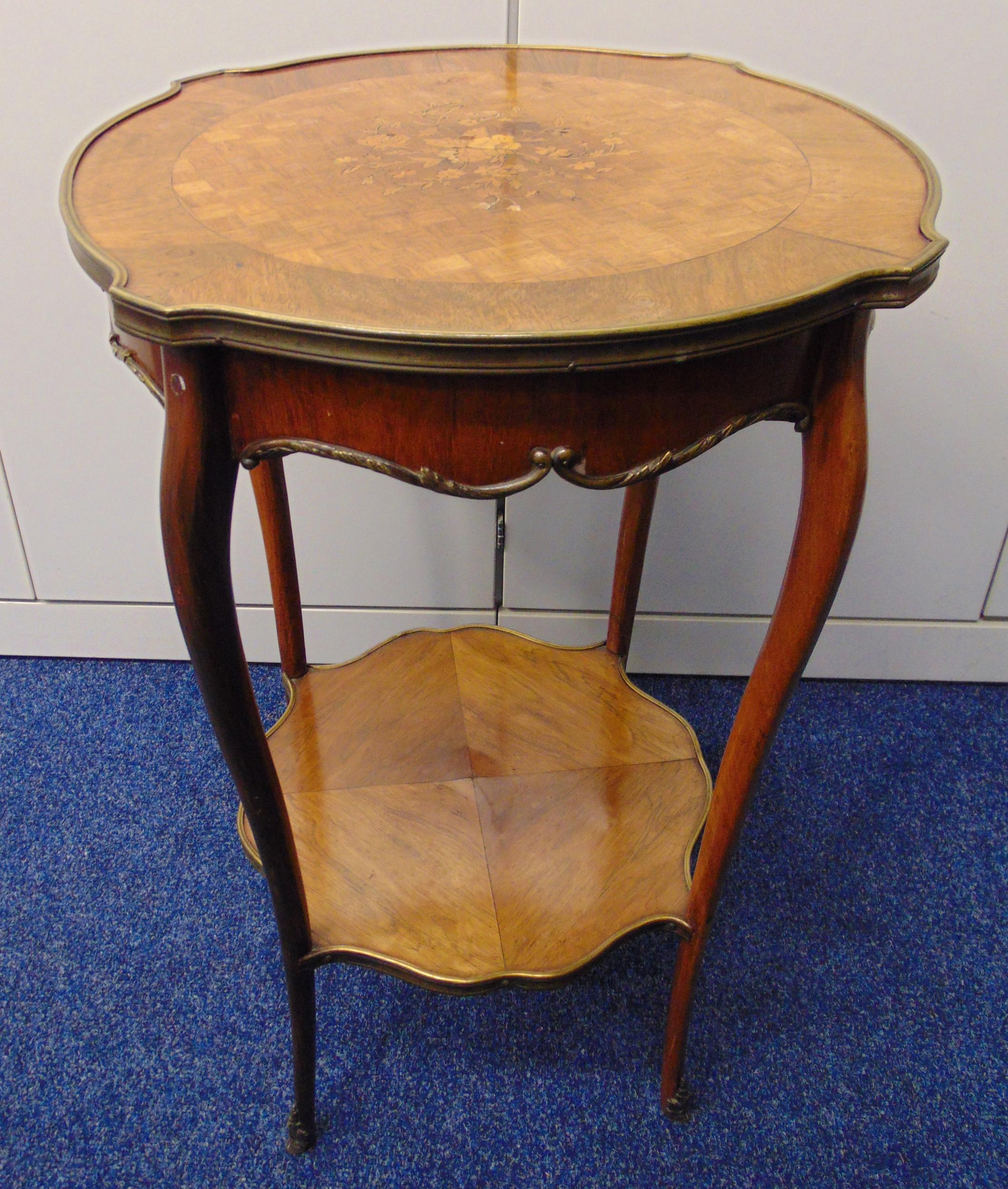 A late Victorian shaped circular two tier side table with inlaid floral spray to the top on four
