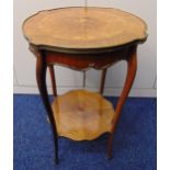 A late Victorian shaped circular two tier side table with inlaid floral spray to the top on four