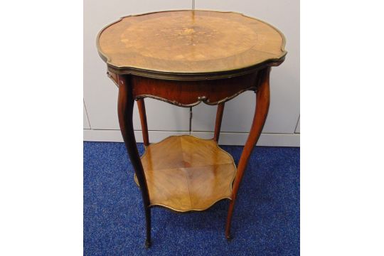 A late Victorian shaped circular two tier side table with inlaid floral spray to the top on four