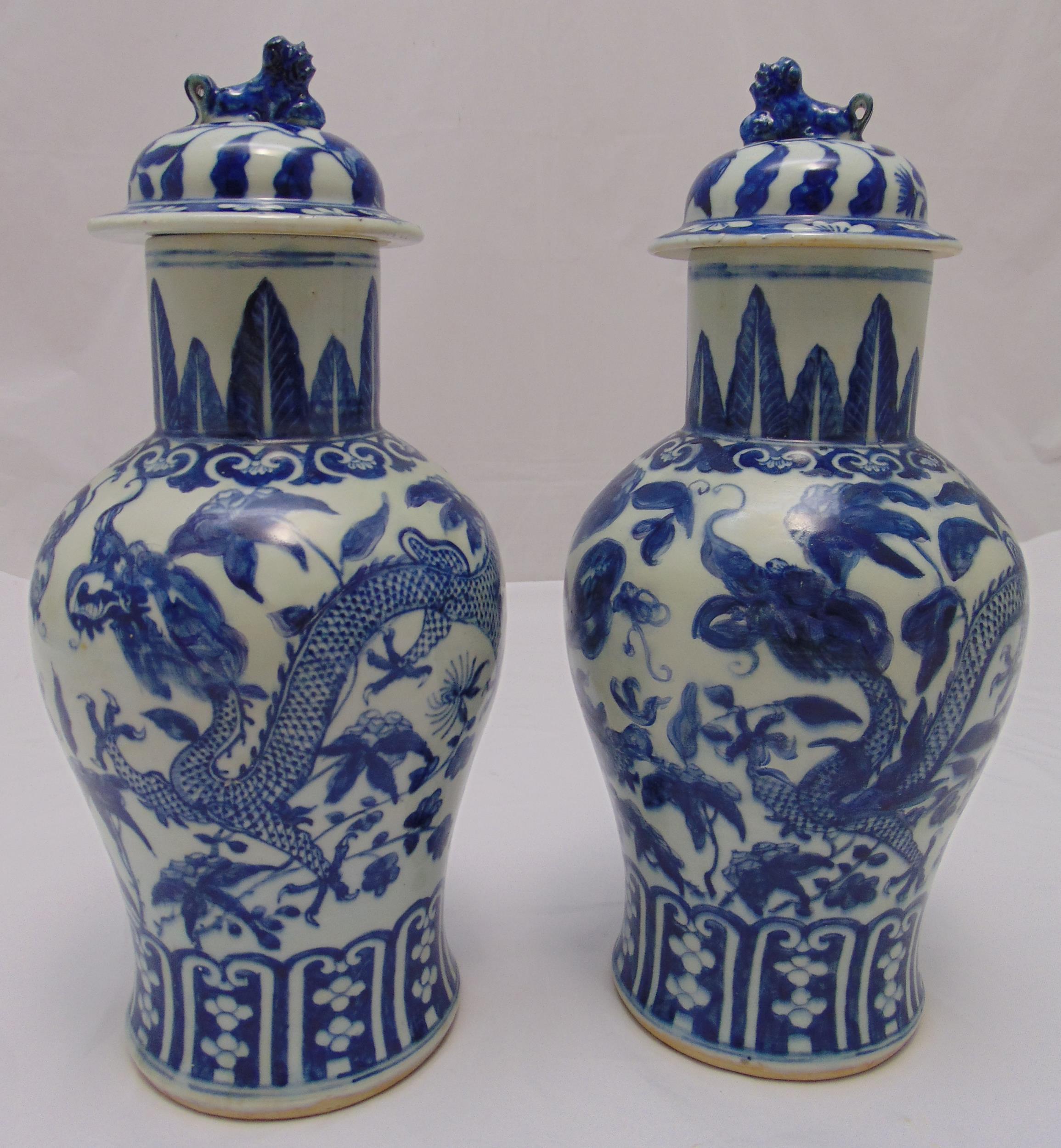 A pair of 19th century style blue & white Chinese baluster vases, the domed pull off covers with