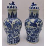 A pair of 19th century style blue & white Chinese baluster vases, the domed pull off covers with