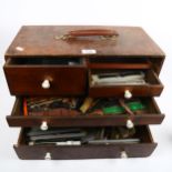 A Vintage watchmaker's table-top tool chest, containing a quantity of wristwatch straps
