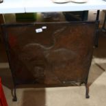 A fire screen with embossed copper panel, depicting a stylised bird, height 65cm