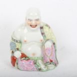 A Chinese hand painted enamelled porcelain seated Buddha, height 21cm
