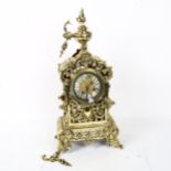A polished cast-brass 8-day mantel clock, with hand painted white enamel numeral panels, case height