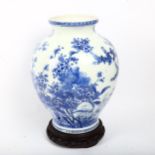 A Chinese blue and white porcelain vase with painted detailed floral design, attached wood base,