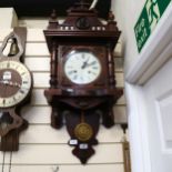 A 1920s oak-cased 8-day wall clock, with pendulum, length 95cm, working order