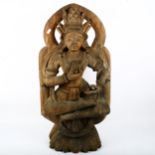 A carved wood deity, height 70cm