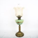 A mid-20th century brass column oil lamp, with painted green glass font and frosted shade, overall