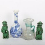 A Japanese blue and white porcelain bottle vase, a pair of Chinese green glaze Dogs of Fo, and a