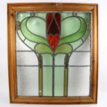 A coloured leadlight glazed panel, pine-framed