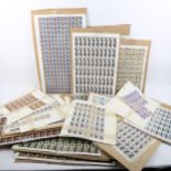 A group of perforated postage stamp sheets