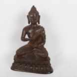 A Chinese patinated and gilded bronze seated Buddha, on double lotus base, height 15cm