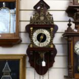 A reproduction brass-mounted wall clock