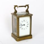 A brass-cased carriage clock, white enamel dial with Roman numeral hour markers, case height 11cm,