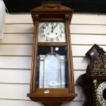 An oak-cased German wall clock with 2-train movement, height 28cm