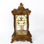 A Victorian gilt-brass 4-glass 8-day mantel clock, white enamel dial with Roman numeral hour markers