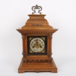 A German light oak architectural 8-day bracket clock, brass dial with silvered chapter ring,