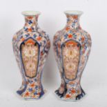 A pair of Japanese Imari style hexagonal baluster vases, height 25cm (repaired chip on 1 rim)