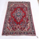 A red ground Sarouk rug, 206cm x 136cm