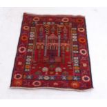 A red ground Beluchi rug, 116cm x 94cm