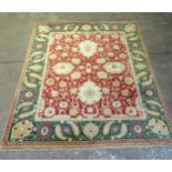 A red and green ground Agra design carpet, 312cm x 248cm (viewing by appointment only)