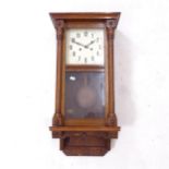 An Edwardian oak-cased 8-day wall clock